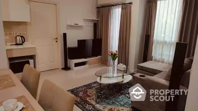 Cozy living room with modern decor and natural light, featuring a stylish rug and comfortable seating.