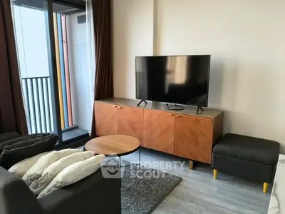 Modern living room with sleek furniture and balcony access