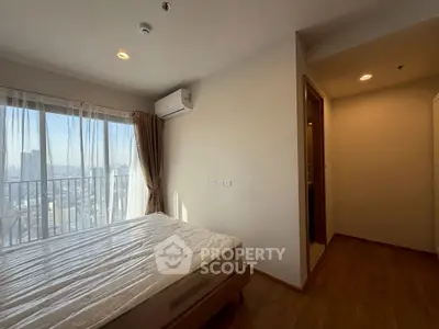 Bright bedroom with city view and air conditioning in modern apartment