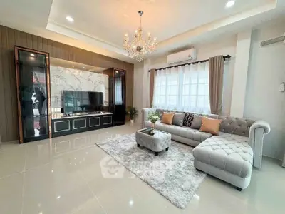 Luxurious living room with elegant chandelier and plush sectional sofa