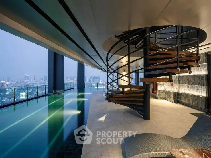 Luxurious rooftop pool with stunning city view and spiral staircase