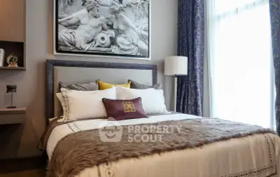 Luxurious bedroom with elegant decor and plush bedding in a modern apartment.
