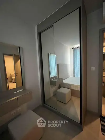 Modern bedroom with mirrored wardrobe and cozy decor