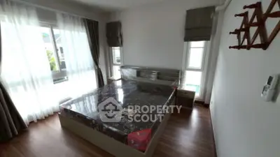 Spacious bedroom with large windows and modern decor