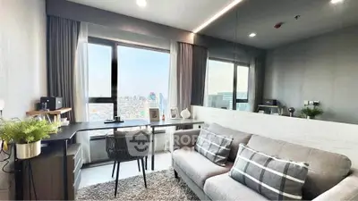 Modern living room with city view, stylish decor, and cozy seating area.