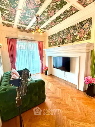Luxurious living room with elegant decor, floral ceiling, and stylish green sofa, perfect for modern living.