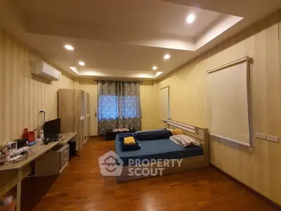 Spacious bedroom with modern decor and ample natural light