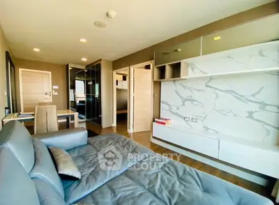 Modern living room with sleek furniture and marble accent wall