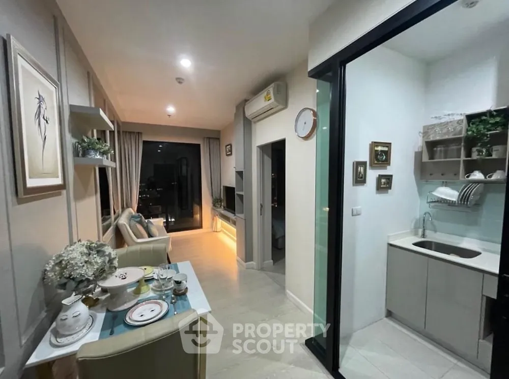 Modern open-layout living room with dining area and stylish kitchen, featuring elegant decor and city view.