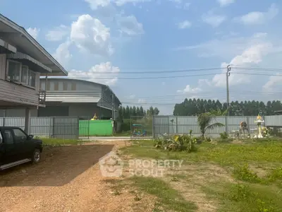 Spacious industrial property with ample outdoor space and secure fencing, ideal for business expansion.