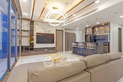 Luxurious modern living room with elegant lighting and open kitchen layout.