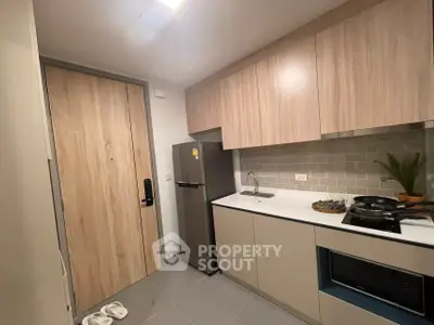 Modern compact kitchen with sleek cabinetry and appliances