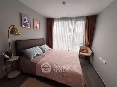 Cozy bedroom with stylish decor and large window for natural light