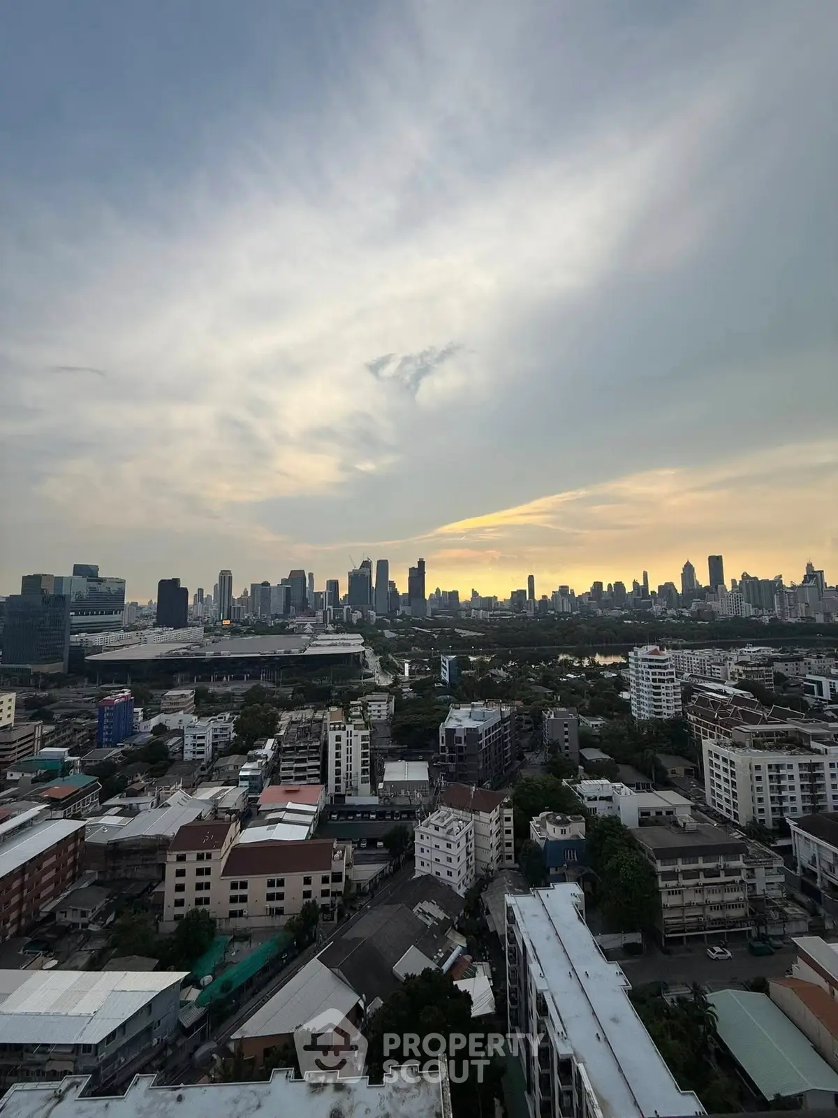 Stunning cityscape view from high-rise building at sunset, showcasing urban skyline and vibrant city life.