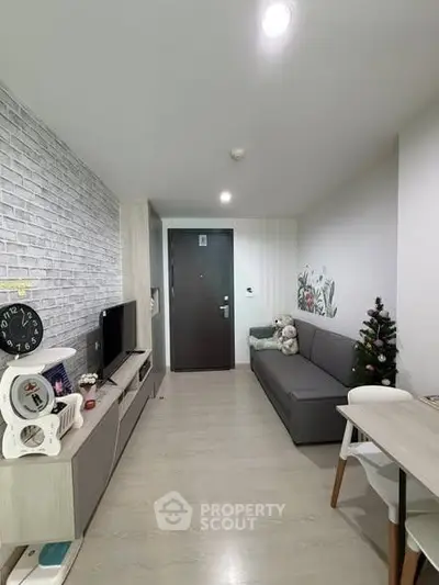 Modern living room with stylish decor and cozy ambiance, featuring a sleek sofa and entertainment unit.