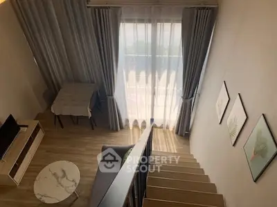 Modern loft-style living room with high ceiling and elegant decor