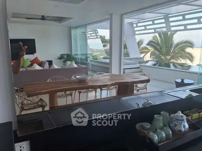 Luxurious open-plan living room with modern decor and stunning balcony view