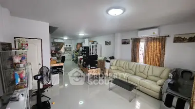 Spacious living room with modern decor and ample natural light