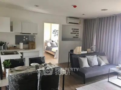 Modern open-plan living room with stylish decor and cozy bedroom view