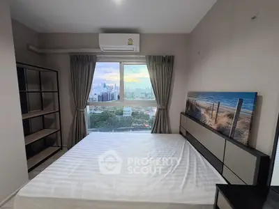 Modern bedroom with city view, featuring large window and stylish decor.