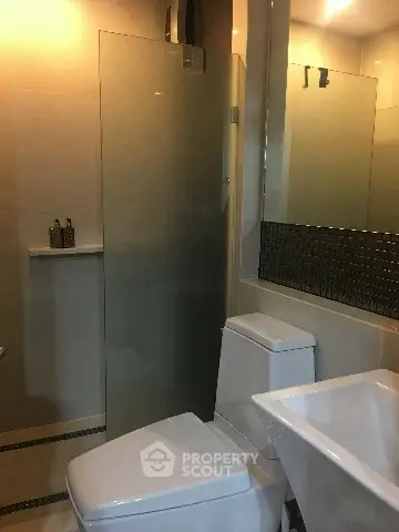 Modern bathroom with sleek fixtures and glass shower enclosure