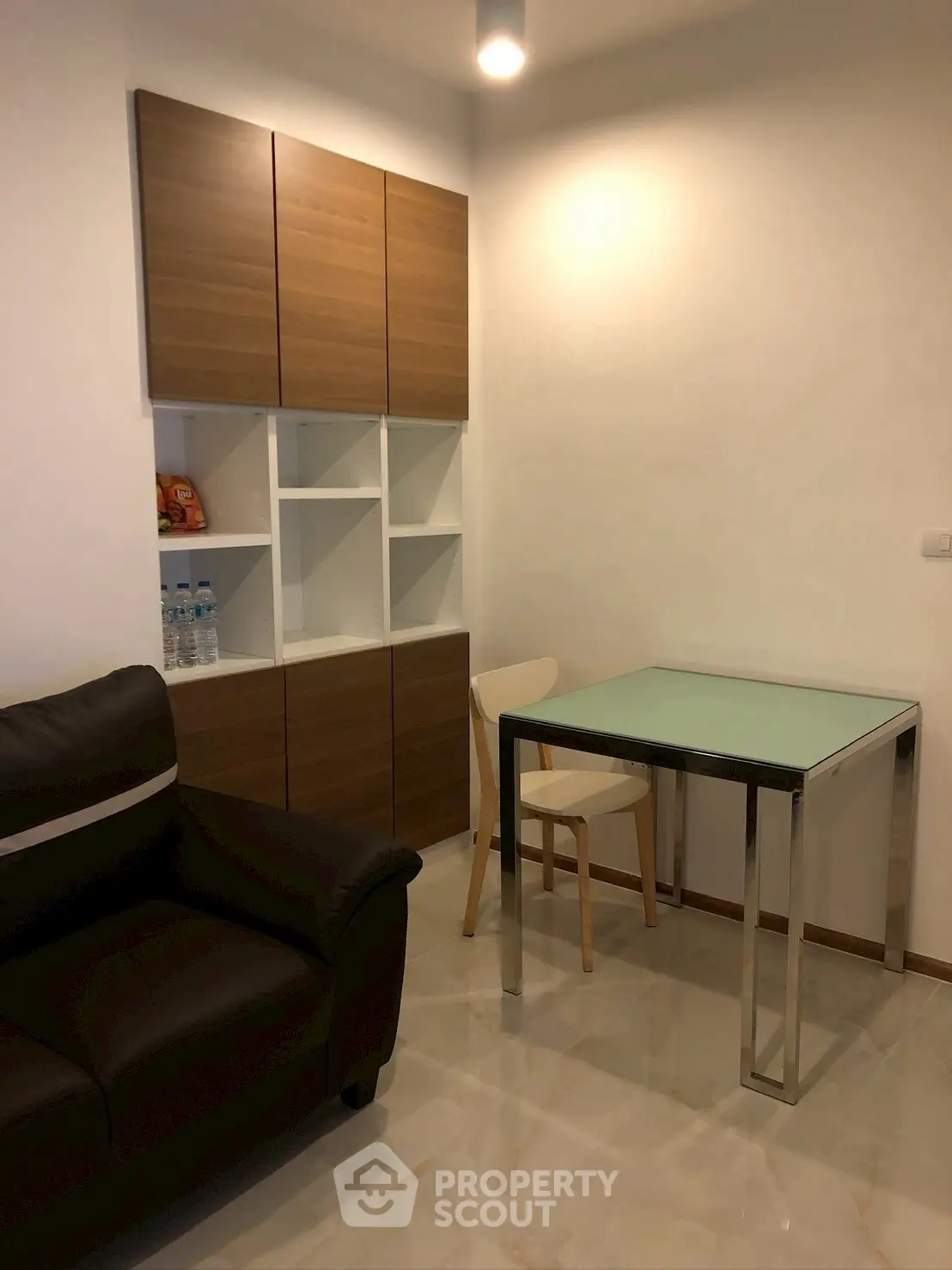 Modern compact living room with sleek furniture and stylish storage cabinets.