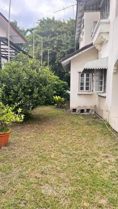 Charming residential property with lush garden and classic architecture, perfect for serene living.