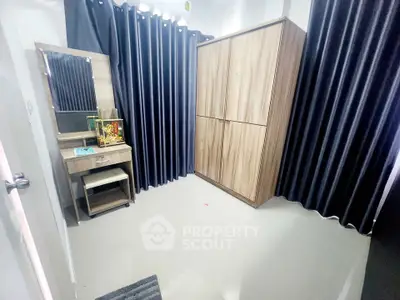 Spacious bedroom with modern wardrobe and stylish curtains