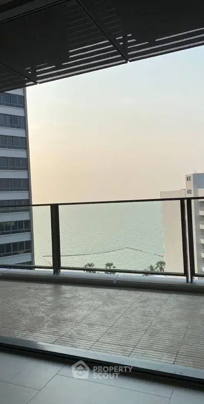 Stunning ocean view from a modern high-rise balcony, perfect for relaxation and enjoying sunsets.