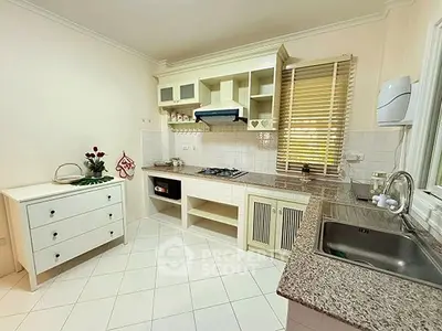 Charming kitchen with granite countertops and gas stove in cozy home