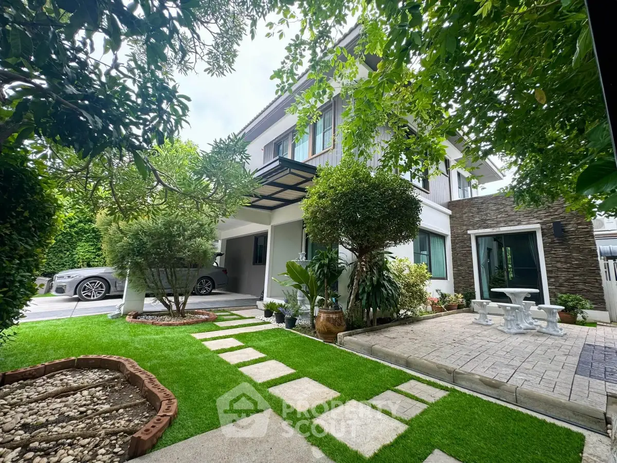 Charming modern house with lush garden and driveway, perfect for family living.