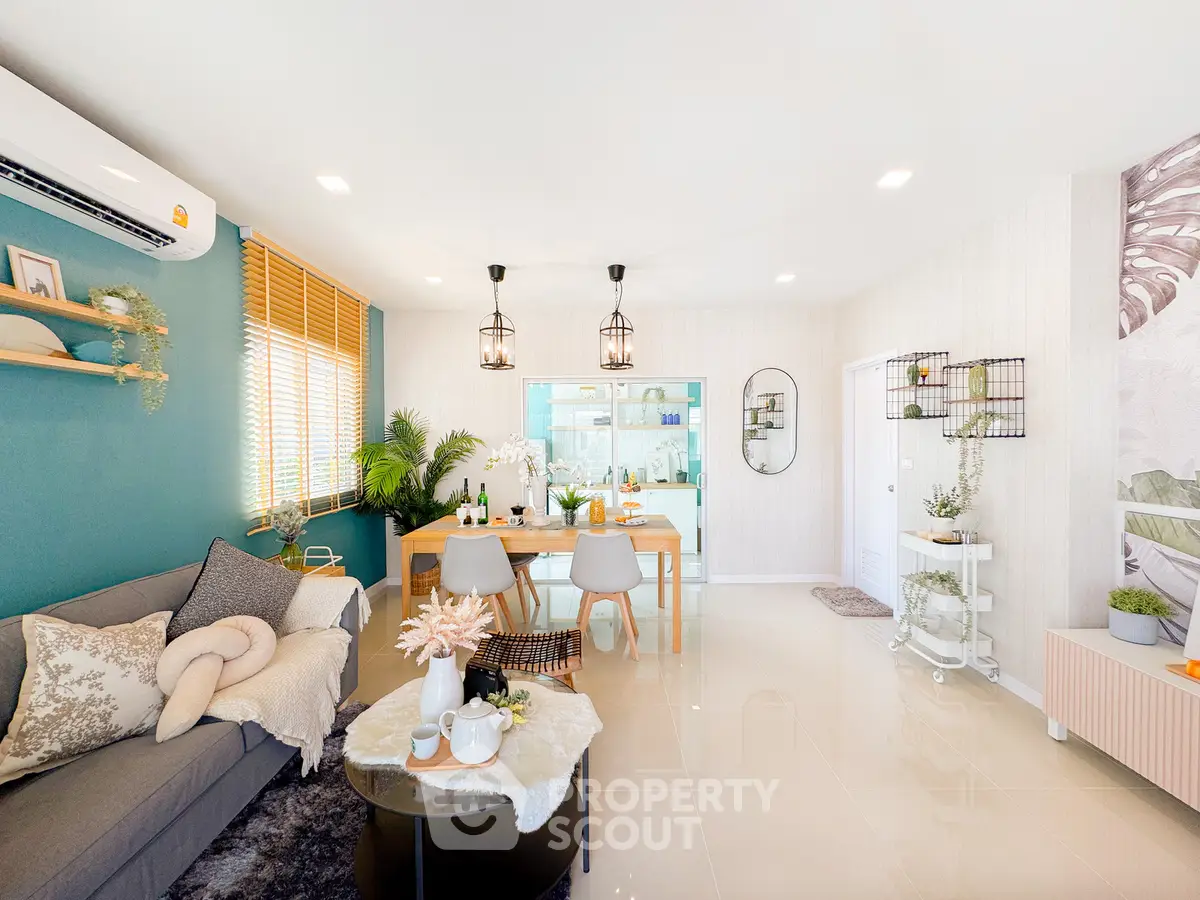Stylish modern living room with open layout, cozy decor, and abundant natural light.