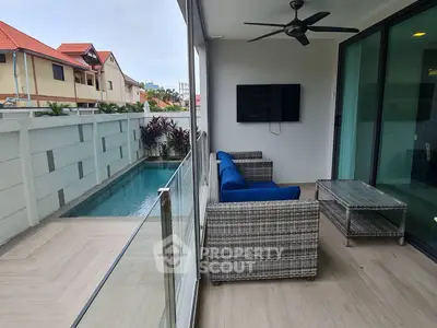 Modern balcony with pool view and stylish outdoor seating area