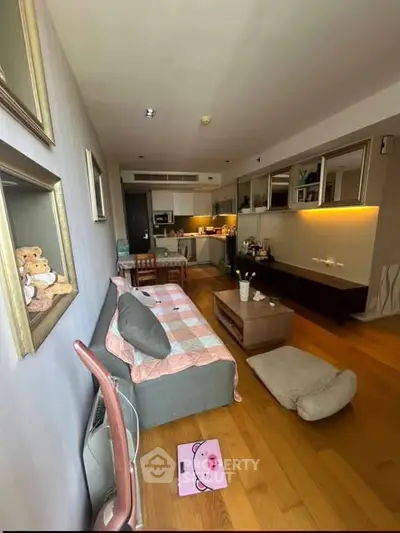 Spacious living room with modern decor and open kitchen layout in a cozy apartment.
