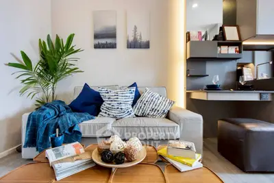 Stylish living room with modern decor, cozy sofa, and elegant lighting, perfect for relaxation and entertaining.