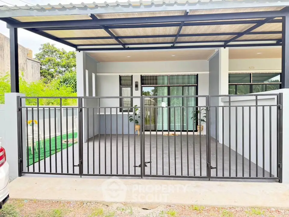 Modern house exterior with gated carport and sleek design