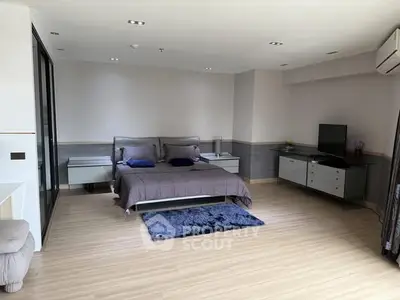 Spacious modern bedroom with stylish decor and natural light