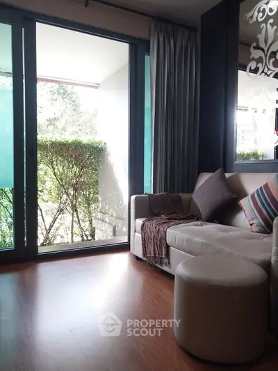 Cozy living room with large windows and balcony view
