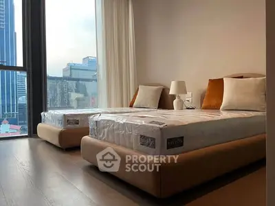 Modern bedroom with twin beds and city view, perfect for urban living.