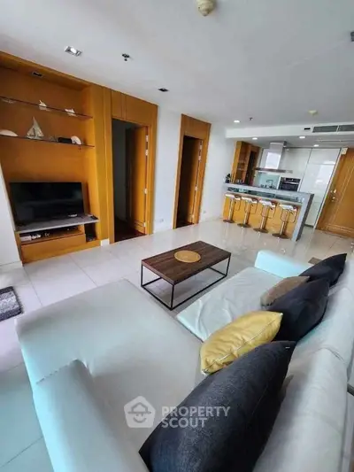 Modern living room with open kitchen and stylish decor in a contemporary apartment.