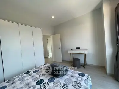 Modern bedroom with stylish decor and ample natural light