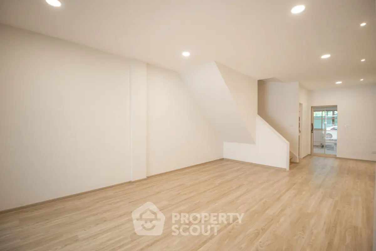 Spacious modern living room with wooden flooring and recessed lighting