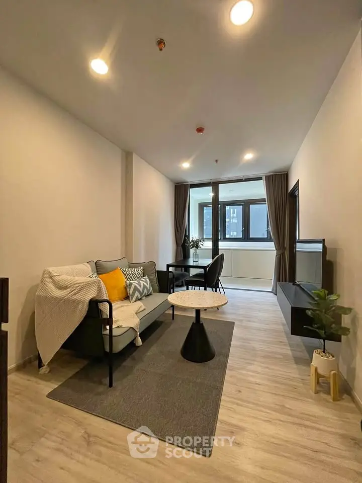 Modern living room with stylish decor and natural light in a contemporary apartment.