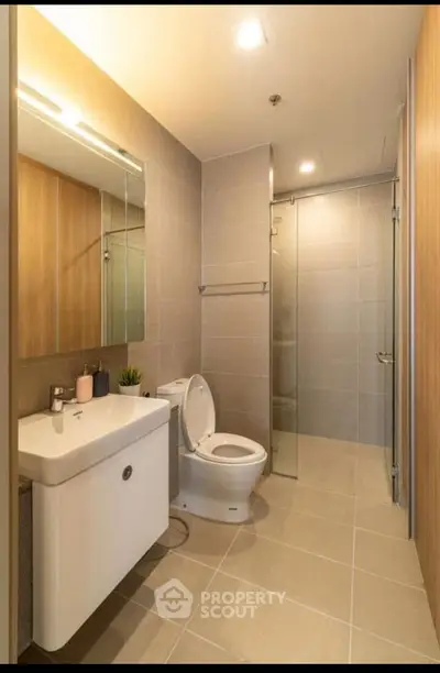 Modern bathroom with sleek fixtures and glass shower enclosure