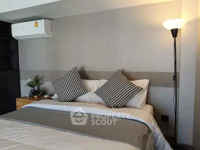 Cozy bedroom with modern decor and stylish lighting, perfect for relaxation and comfort.