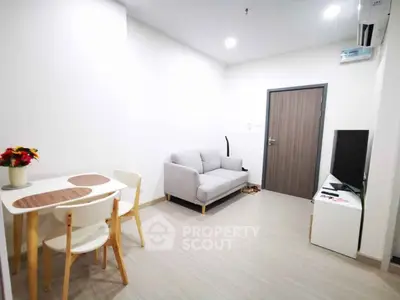 Modern living room with cozy sofa and dining area in a bright apartment.
