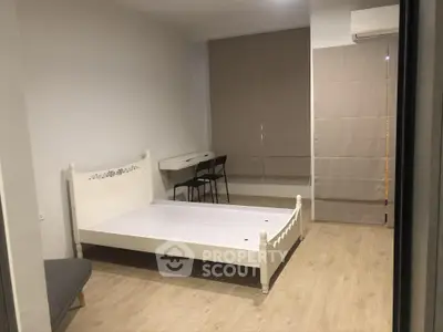 Spacious bedroom with minimalist decor and natural light