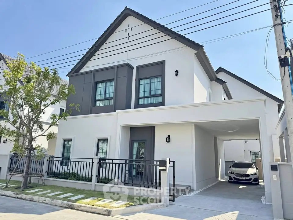 Modern two-story house with carport and sleek exterior design