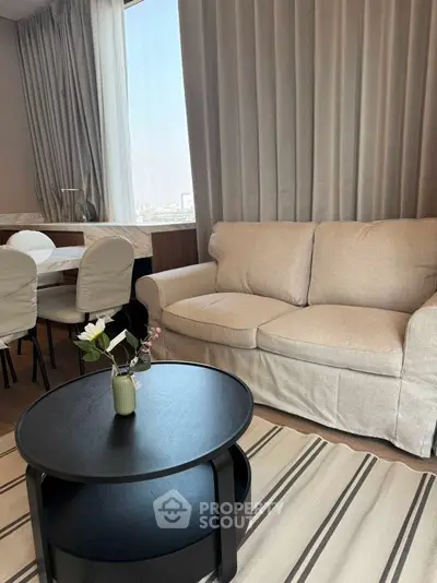 Elegant living room with beige sofa and modern black coffee table