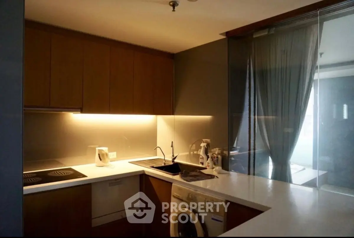 Modern kitchen with sleek design, featuring built-in appliances and stylish lighting.